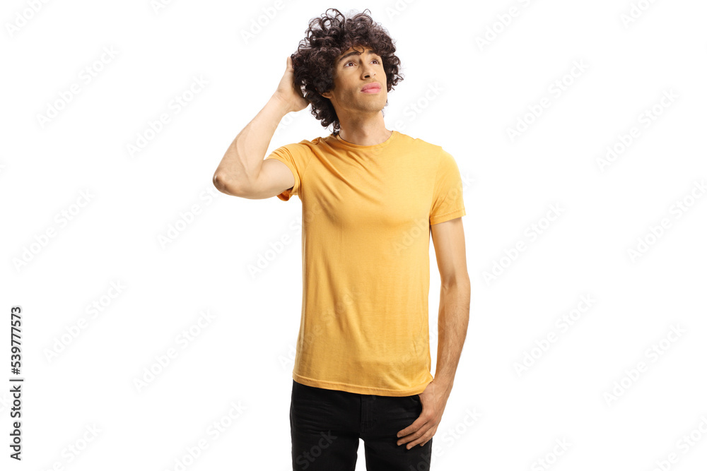 Pensive young man with curly hair looking up and holding head Pensive young man with curly hair looking up and holding head