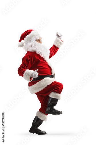 Full length profile shot of happy Santa Claus standing dancing