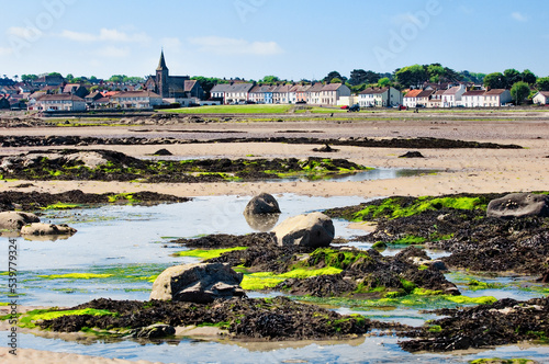 Low tide across the beach at Ballywalter village on the Irish Sea coast of the Ards peninsula, County Down, Northern Ireland. photo