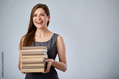 Smiling woman holding pile books. Isolated advertising portrait.
