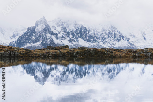 mountain landscape with snow reflection in lake © ArinaPhotography