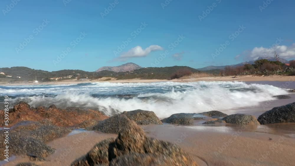 Low angle view of sand beach and waves at sunset in Corsica. Stabilized high quality color graded footage Low angle view of sand beach and waves at sunset in Corsica. Stabilized high quality color graded footage