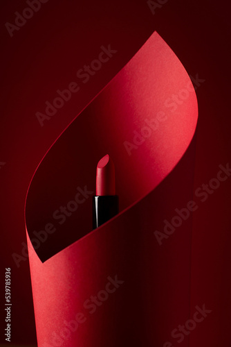 red lipstick wrapped in red paper on a red background