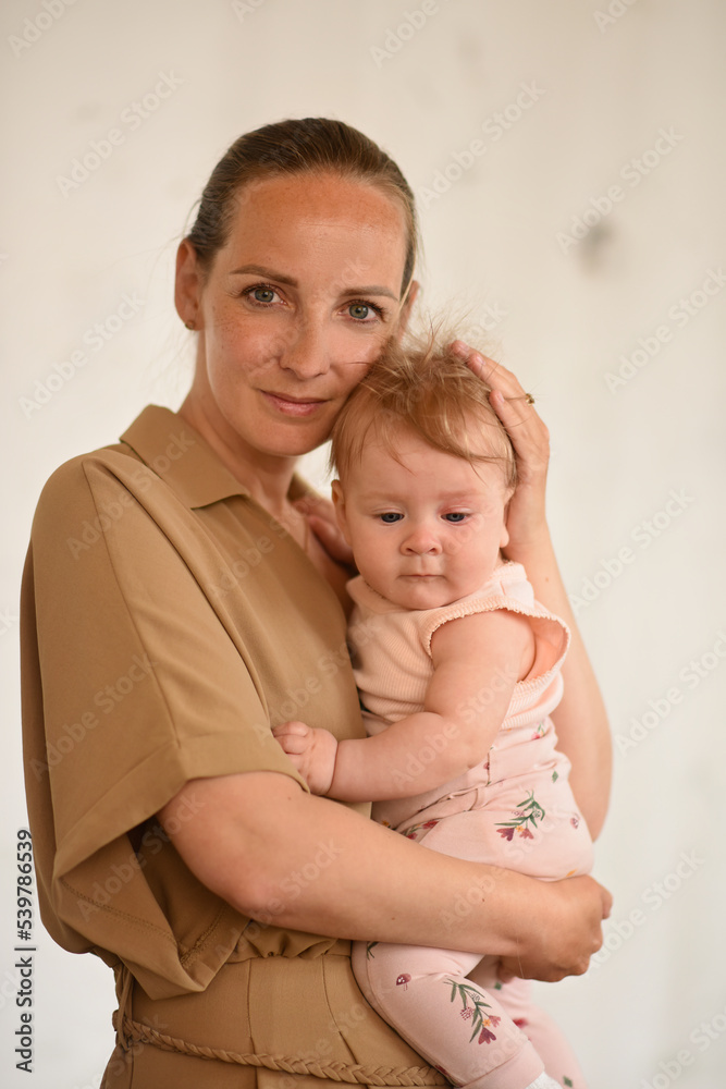 Mom holds the baby in her arms