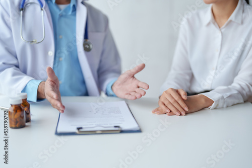Doctor who records a patient's detailed information or medication history is evaluating medications and vaccines for the intended treatment. or if there are any side effects. © amnaj