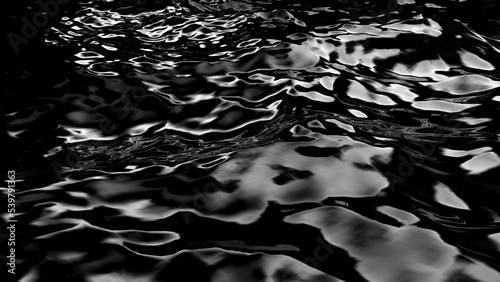 3D rendering of black water wave surface. Geometric computer graphic background of glossy reflective sea or ocean surface texture with ripples. Oil or petroleum spill. Bumpy form of liquid.