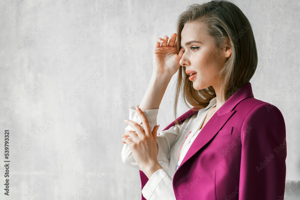 Fototapeta premium Young businesswoman. Beautiful woman director, head, general manager, ceo in astylish bright business pink, fuchsia color suit at photoshoot in armchair. Business purposeful ambitious girl careerist