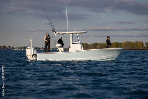 People fishing on a center-console boat.