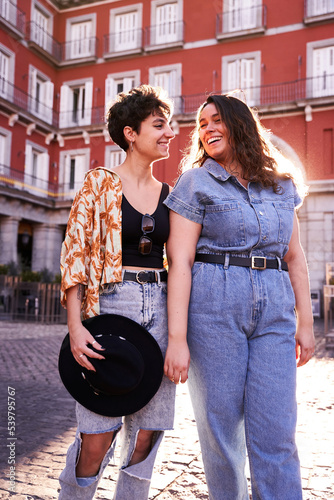 Cheerful young women on cobbled street