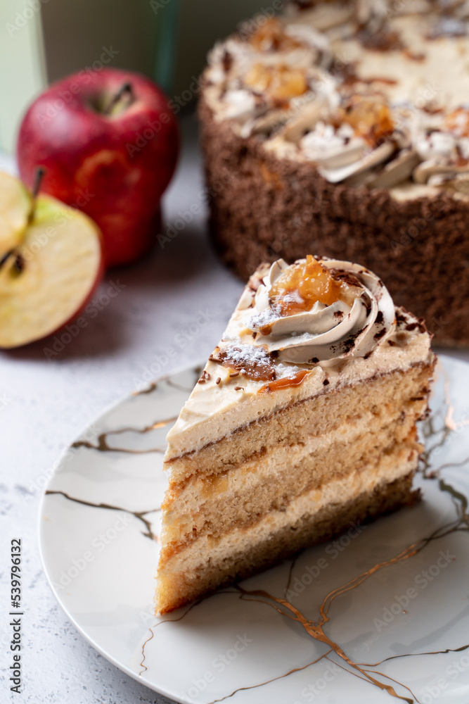 Seasonal birthday cake with sliced apples and a whole cake on background, menu studio shot