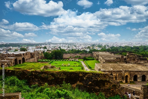 Canvas Print High-angle of Golconda Fort ruins with grass around and cloudy sky background
