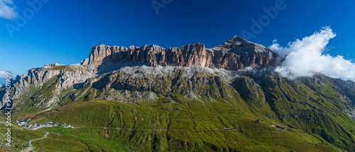 The landscape of the Dolomites seen from the Sella group: one of the most famous and spectacular mountain massifs in the Alps, near the town of Canazei, Italy - July 2022. photo