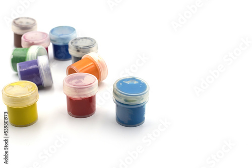 Jars of paint for drawing different colors on a white background isolated