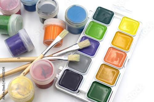 Paints for drawing on a white background. Paint brushes