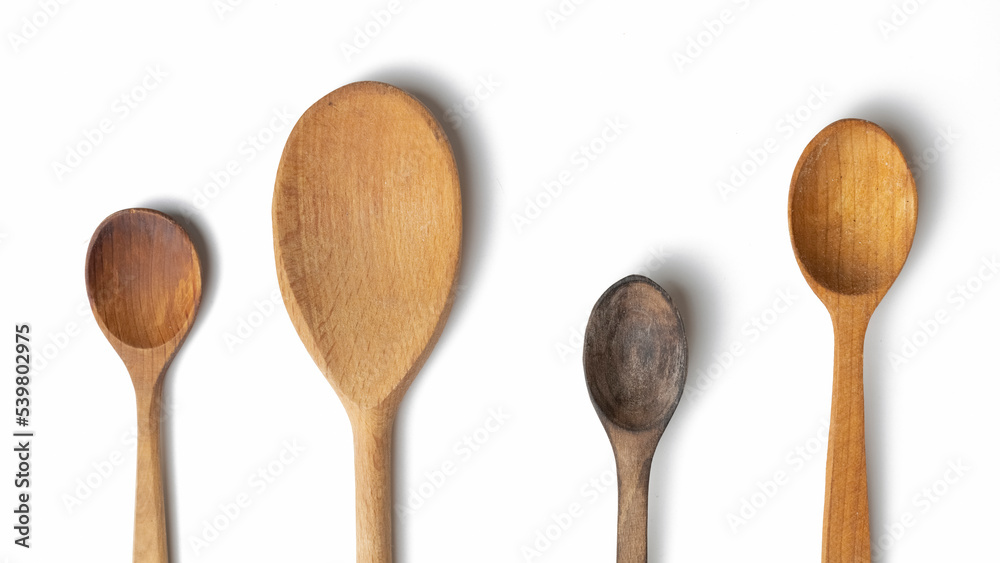 Wooden kitchen utensils and spoons isolated on white background Wooden kitchen utensils and spoons isolated on white background