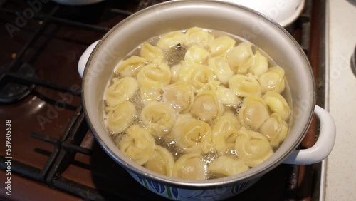 Dumplings are boiled in a saucepan in boiling water