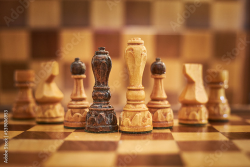 Print op canvas Pieces of chess on a chessboard, natural light, bright wooden material