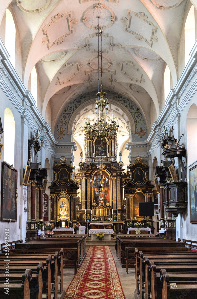 Main nave and presbytery of Holy Mary of Mirow sanctuary within Franciscan monastery in historic old town quarter of Pinczow in Poland