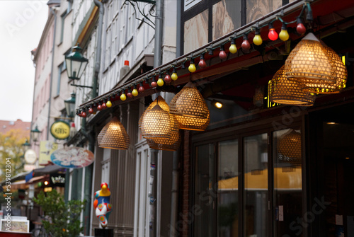 Canvas Print background of European city street with garlands, shop windows, cafe signboards