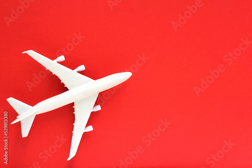 a plane on a red background. concept of travel, toys for children