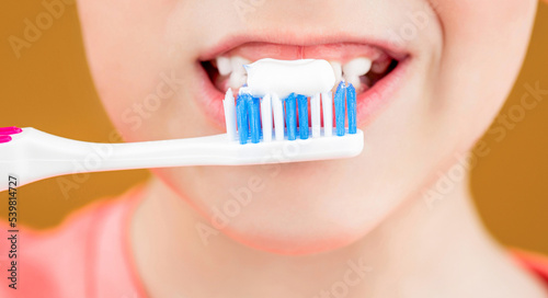 Dental hygiene. Happy little kid brushing her teeth. Health care, dental hygiene. Kid boy brushing teeth. Boy toothbrush white toothpaste. Joyful child shows toothbrushes. Little boy cleaning teeth