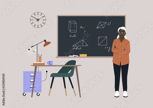 A senior Geometry teacher standing next to a chalkboard with arms crossed