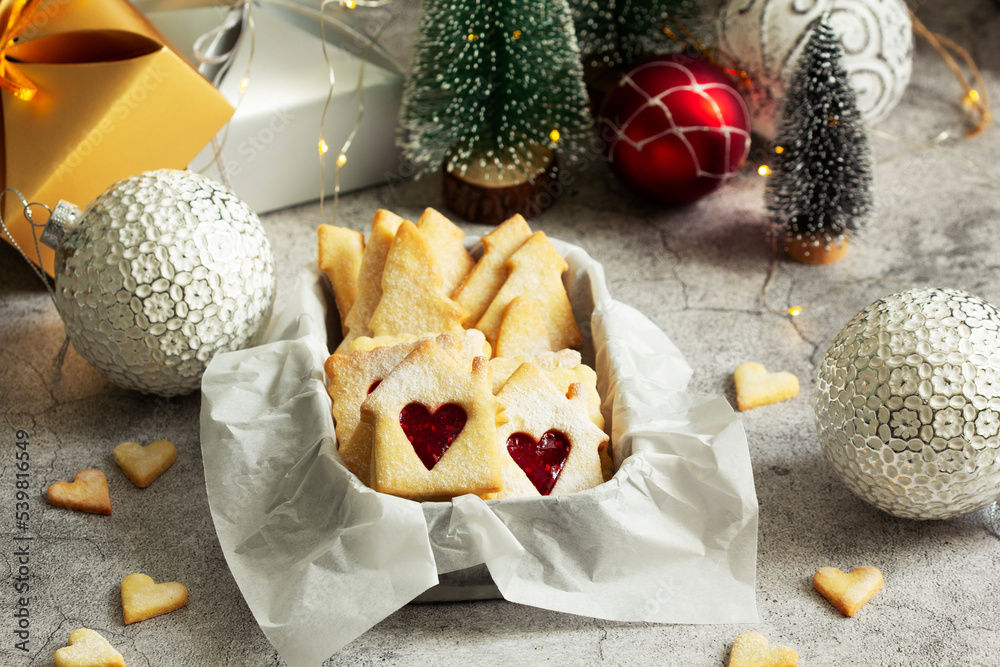 Sugar cookies stuffed with raspberry jam on a light background. Christmas and New Year's decor.