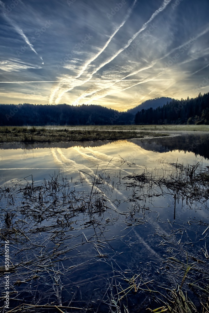 Fototapeta premium Sunrise over the calm St. Joe River in Idaho.