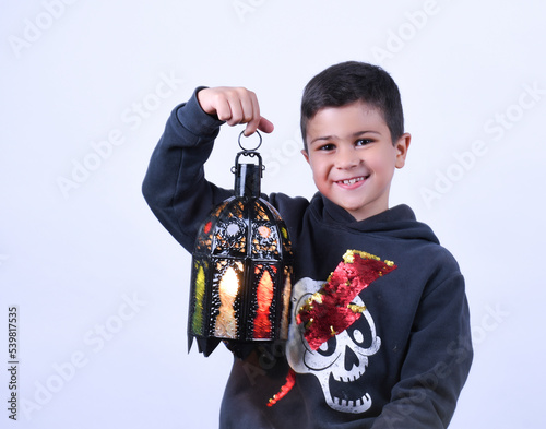 cute Moroccan boy posing in a photography studio.