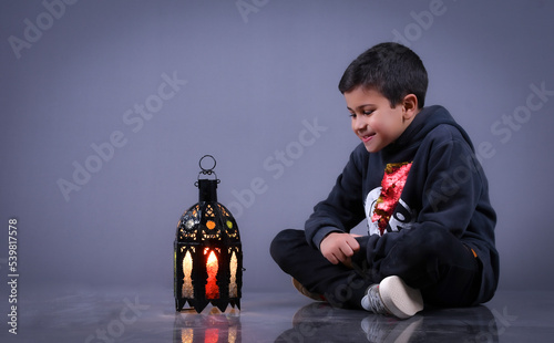 cute Moroccan boy posing in a photography studio.