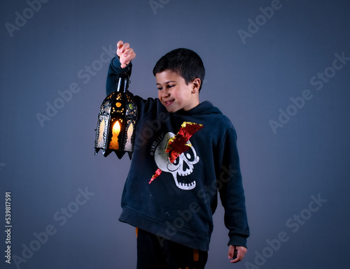 cute Moroccan boy posing in a photography studio.