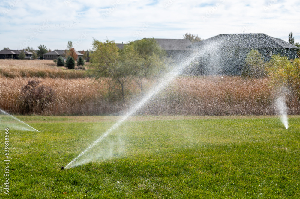 winterizing a irrigation sprinkler system by blowing pressurized air through to clear out water - obrazy, fototapety, plakaty 