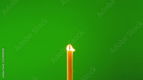 fire flame glowing candle on windy on green screen background of slow motion