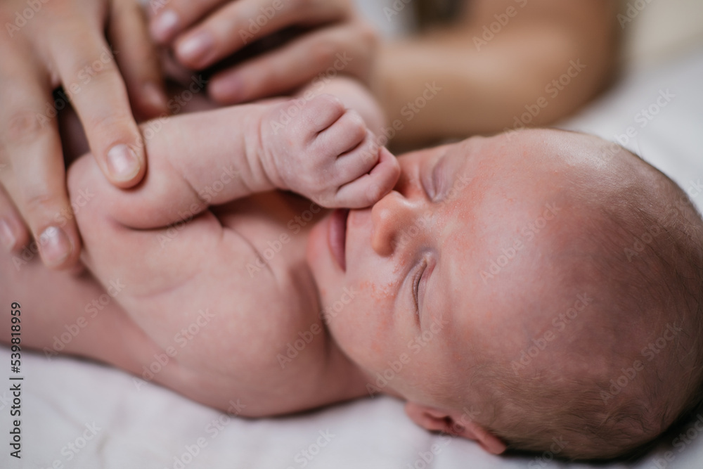 two week old very cute baby naked on a white sheet. High quality photo two week old very cute baby naked on a white sheet. High quality photo