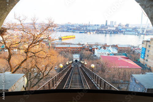 View of funicular rails, Golden Horn Bay and city of Vladivostok, Russia from cab of funicular on slope of Eagle Hill. Rail transport