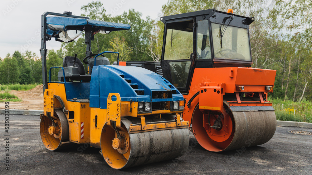 Old paver close-up. Road roller. Road construction concept Old paver close-up. Road roller. Road construction concept