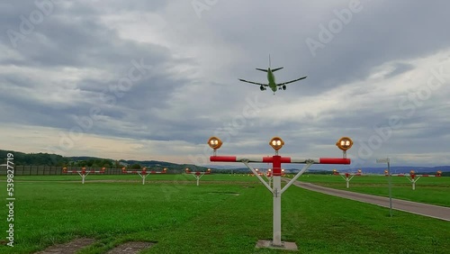 Slow motion airplane landing above landing lights on Zurich airport