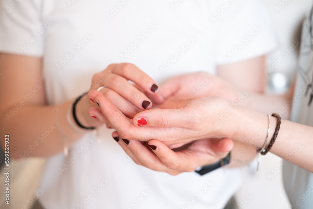 Fototapeta premium Close-up of the holding hands of a lesbian couple