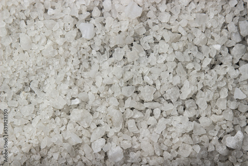 Coarse rock salt in full screen as a background for the image. Rock salt texture