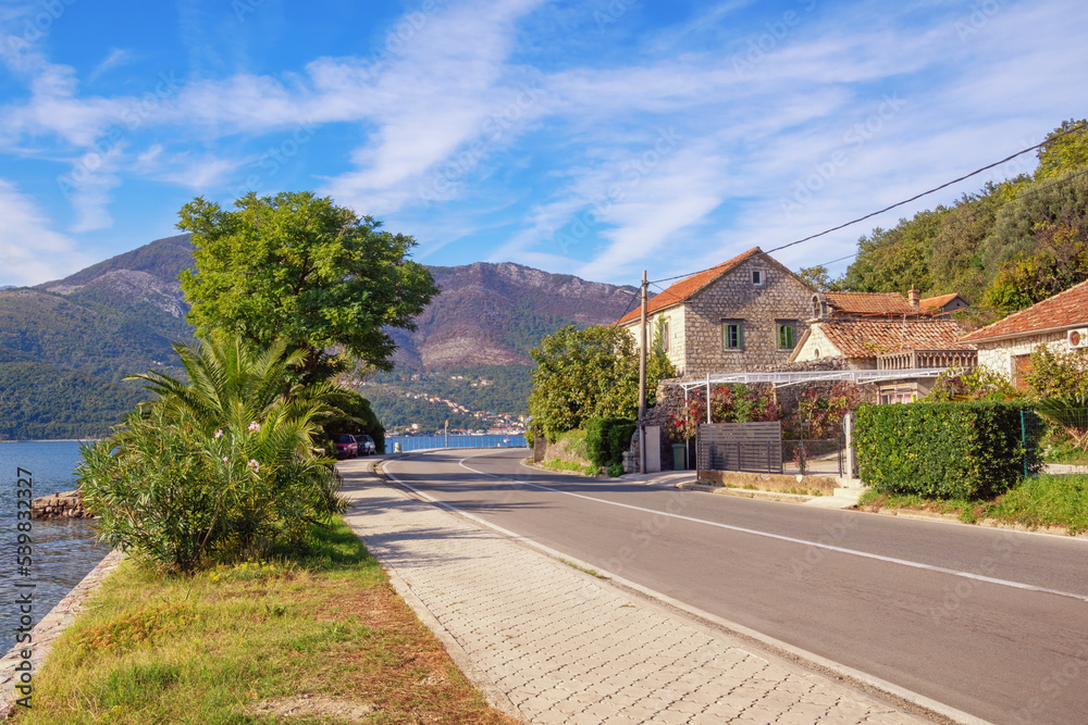 Autumn Balkan road trip. View of Adriatic Highway (Jadranska magistrala) running along coast of Kotor Bay. Montenegro, Donja Lastva village Autumn Balkan road trip. View of Adriatic Highway (Jadranska magistrala) running along coast of Kotor Bay. Montenegro, Donja Lastva village