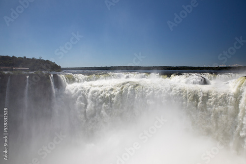 Nature s power. View of the Iguazu waterfalls and river  seen from Garganta del Diablo  in Misiones  Argentina. The amazing falls and falling white water beautiful texture  mist and splash.