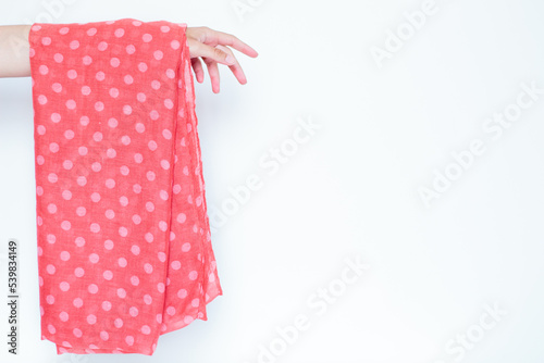 Fashion look with polka dot pattern scarf. Feminine fashion concept.