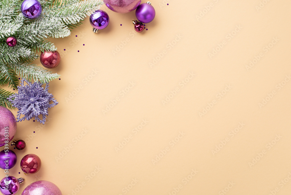 New Year concept. Top view photo of pink and violet baubles flower ornament fir branch in hoarfrost and purple sequins on isolated pastel beige background with copyspace