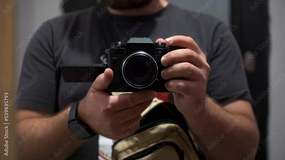 male blogger hold camera in front of mirror, reflection of video camera or camera in mirror, shooting directly image from mirror surface. camera records itself in mirror. male blogger hold camera in front of mirror, reflection of video camera or camera in mirror, shooting directly image from mirror surface. camera records itself in mirror.