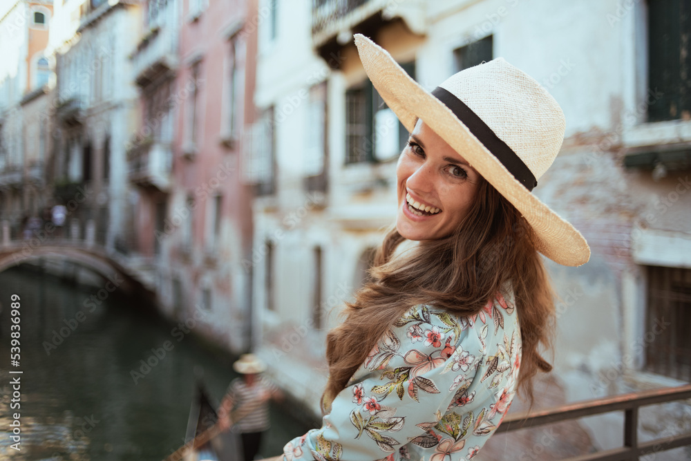 smiling elegant woman in floral dress exploring attractions