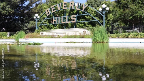 Beverly Gardens Park and the BEVERLY HILLS sign on Santa Monica Blvd. Beverly Hills, California