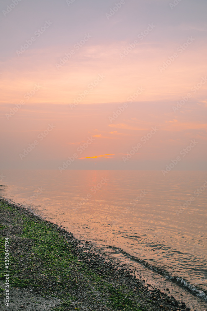 pink smoky sunset on rocky Carkeek Park beach in Seattle with low tide