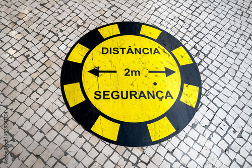 2 meters safety distance sticker on the street pavement in Lisbon photo