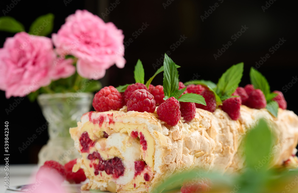Baked meringue roll with cream and fresh red raspberry Baked meringue roll with cream and fresh red raspberry