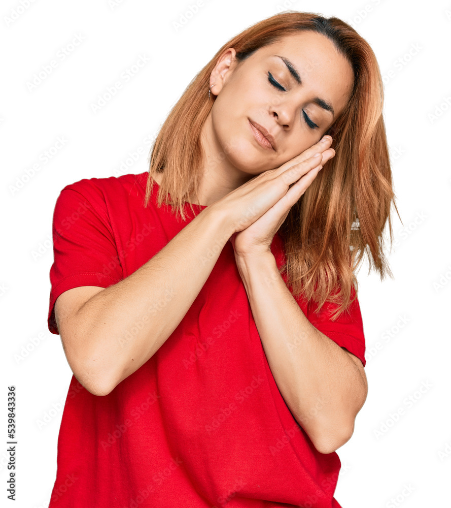 Hispanic young woman wearing casual red t shirt sleeping tired dreaming and posing with hands together while smiling with closed eyes. Hispanic young woman wearing casual red t shirt sleeping tired dreaming and posing with hands together while smiling with closed eyes.